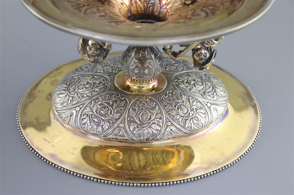 A handsome pair of Victorian parcel gilt silver oval comports by Hunt & Roskell (lacking glass bowls),